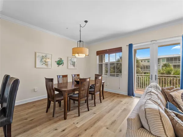 a view of a dining room with furniture wooden floor and chandelier
