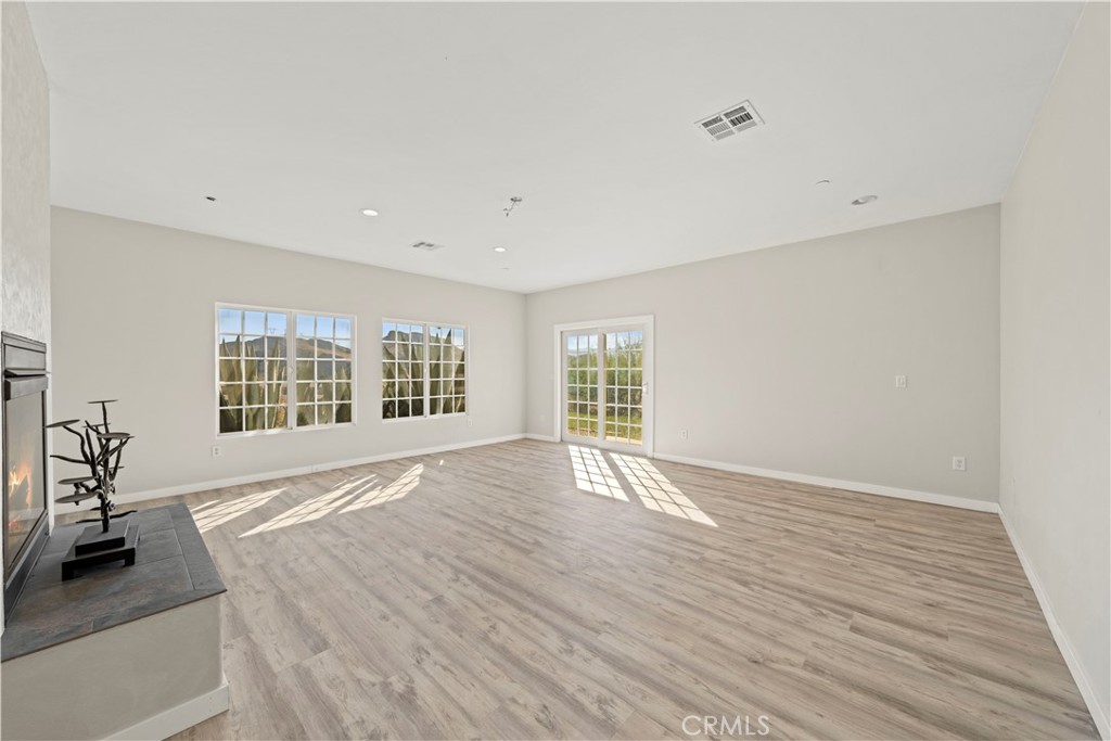 13560 Sego Road Agua Dulce, CA 91390 - Photo 19 of 75 a view of an empty room with wooden floor and a window
