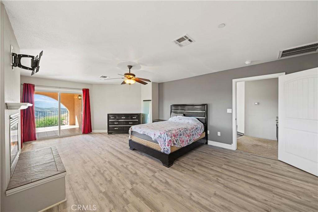 13560 Sego Road Agua Dulce, CA 91390 - Photo 26 of 75 a spacious bedroom with a bed and a dresser