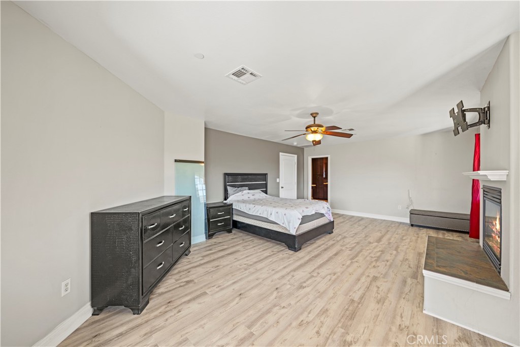 13560 Sego Road Agua Dulce, CA 91390 - Photo 29 of 75 a bedroom with a bed and wooden floor
