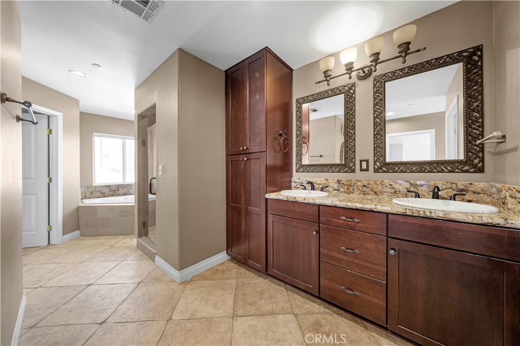 13560 Sego Road Agua Dulce, CA 91390 - Photo 32 of 75 a bathroom with a granite countertop sink mirror and
