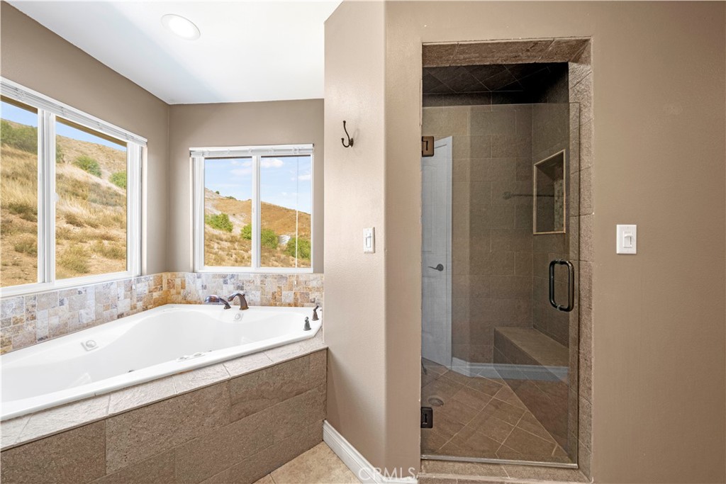 13560 Sego Road Agua Dulce, CA 91390 - Photo 36 of 75 a bathroom with a bathtub and a shower