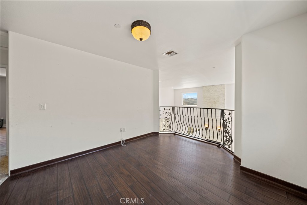 13560 Sego Road Agua Dulce, CA 91390 - Photo 40 of 75 a view of a hallway with wooden floor