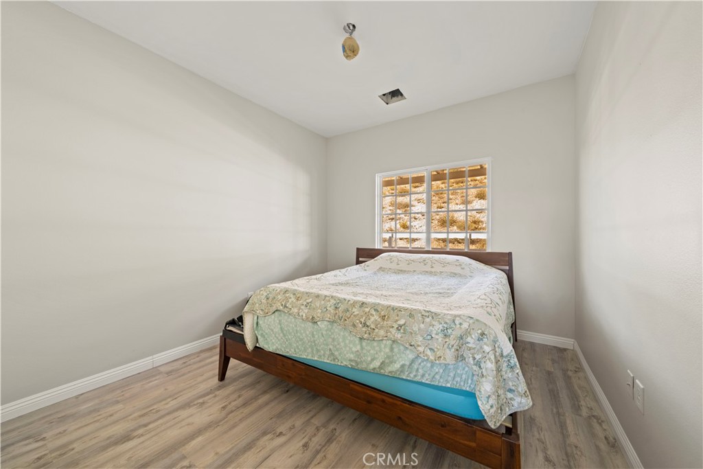 13560 Sego Road Agua Dulce, CA 91390 - Photo 43 of 75 a bed sitting in a bedroom next to a window