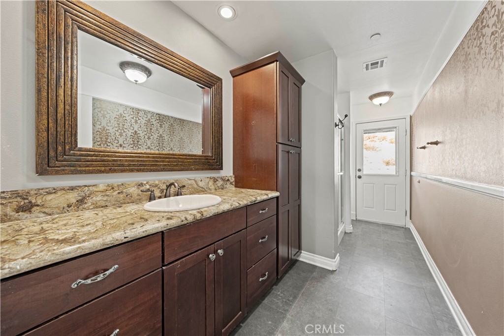 13560 Sego Road Agua Dulce, CA 91390 - Photo 47 of 75 a bathroom with a sink and a mirror