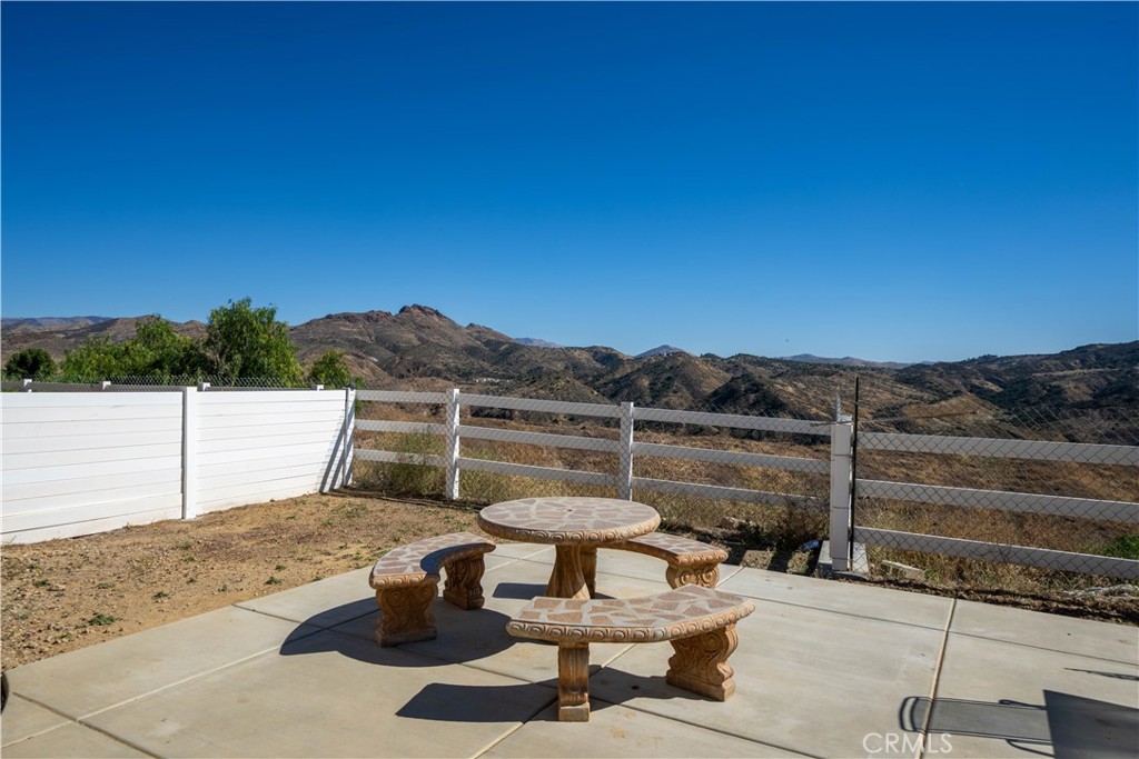 13560 Sego Road Agua Dulce, CA 91390 - Photo 59 of 75 a view of a lake with a table and chairs