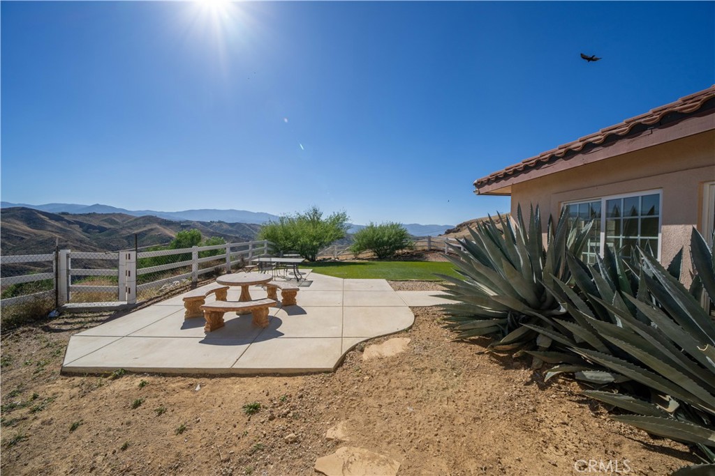 13560 Sego Road Agua Dulce, CA 91390 - Photo 61 of 75 a view of a backyard with plants and a patio