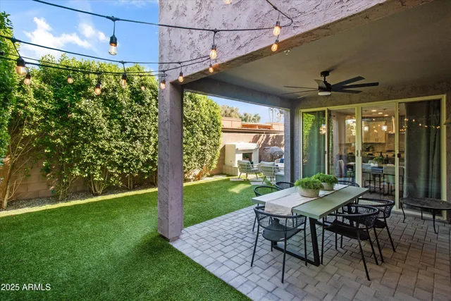 a patio with garden area and outdoor seating