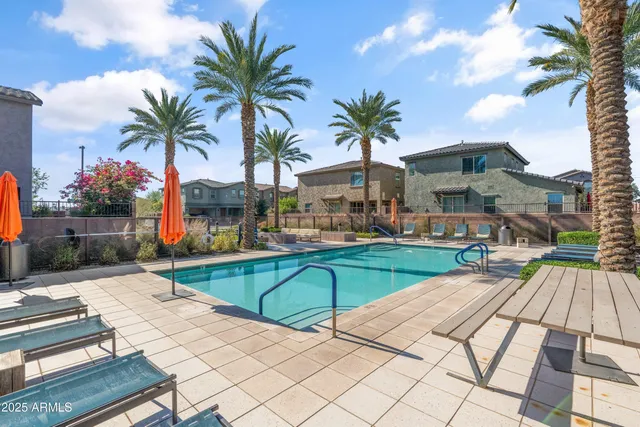 a view of multiple houses with swimming pool