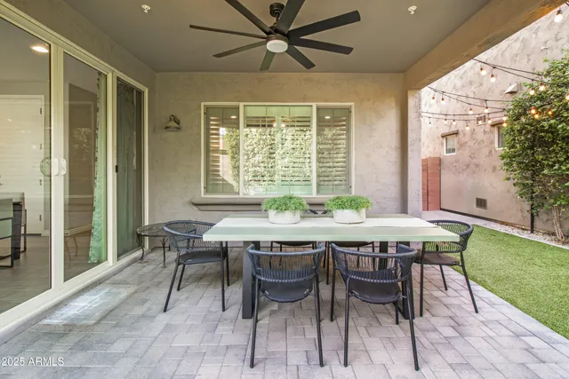 a dining room with a wooden table and chairs