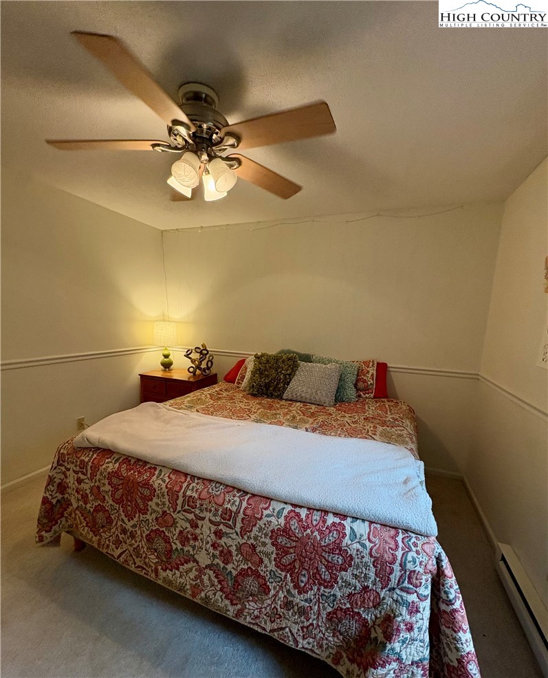 5416 Bamboo Road Boone, NC 28607 - Photo 20 of 35 a bedroom with a bed and a chandelier