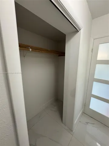 a view of a kitchen with wooden floor and electronic appliances