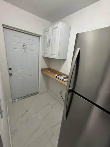 a kitchen with white cabinets