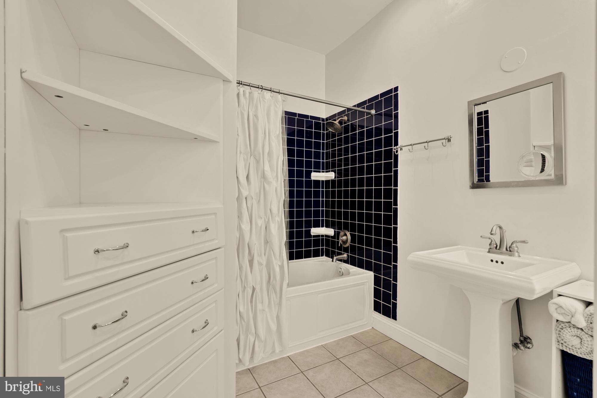 1933 18th Street Northwest, Unit 304 Washington, DC 20009 - Photo 14 of 24 a bathroom with a bathtub sink vanity and mirror