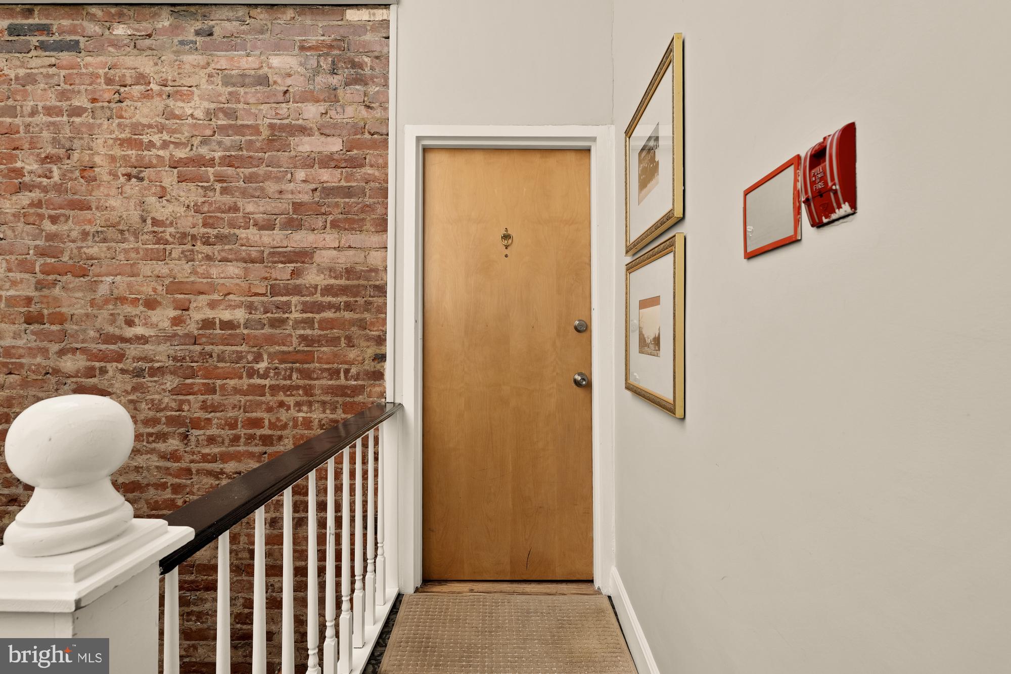 1933 18th Street Northwest, Unit 304 Washington, DC 20009 - Photo 17 of 24 a view of a hallway with wooden door and stairs