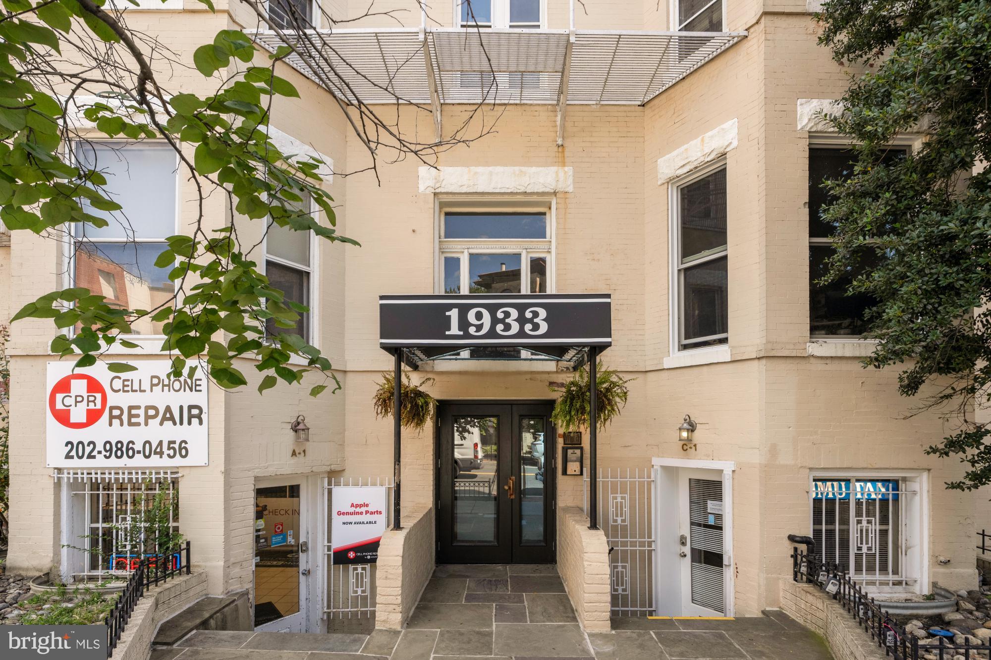 1933 18th Street Northwest, Unit 304 Washington, DC 20009 - Photo 19 of 24 a front view of a building with retail shops