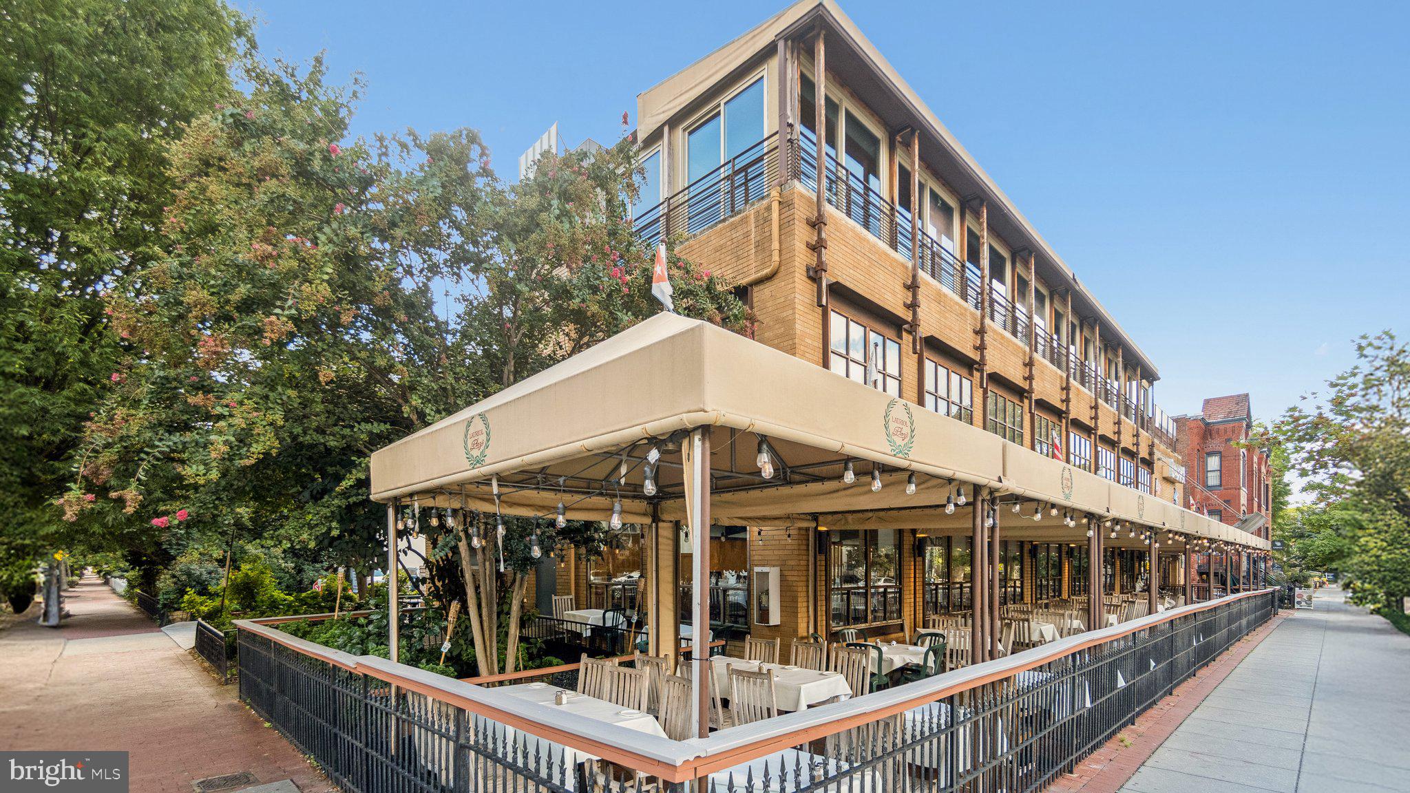 1933 18th Street Northwest, Unit 304 Washington, DC 20009 - Photo 24 of 24 a view of a large building with large windows and a small yard