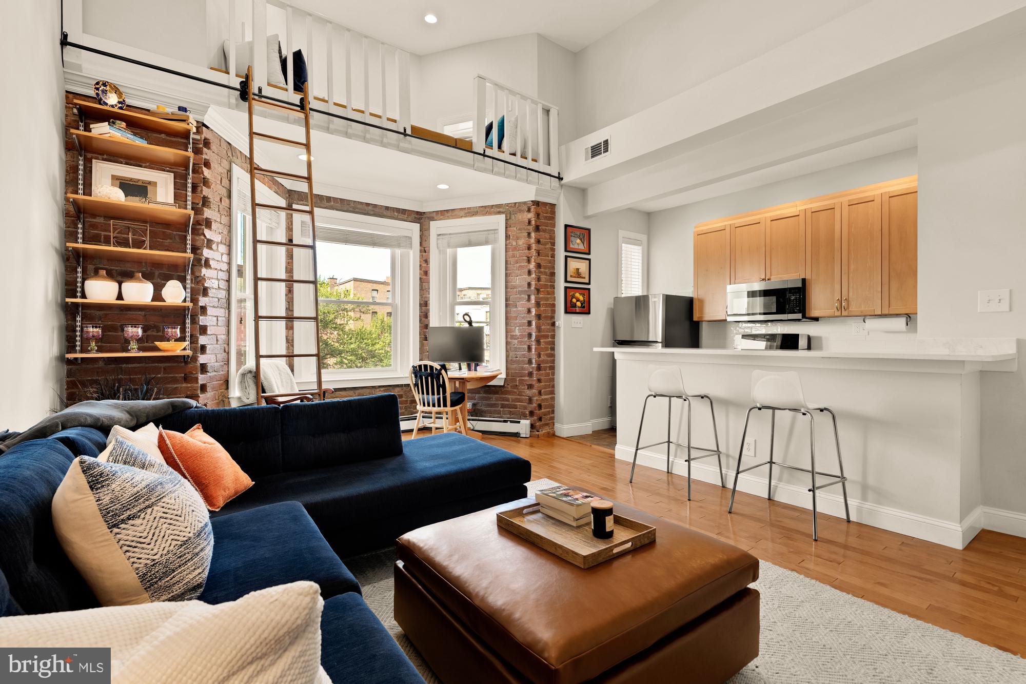 1933 18th Street Northwest, Unit 304 Washington, DC 20009 - Photo 5 of 24 a living room with furniture and a flat screen tv