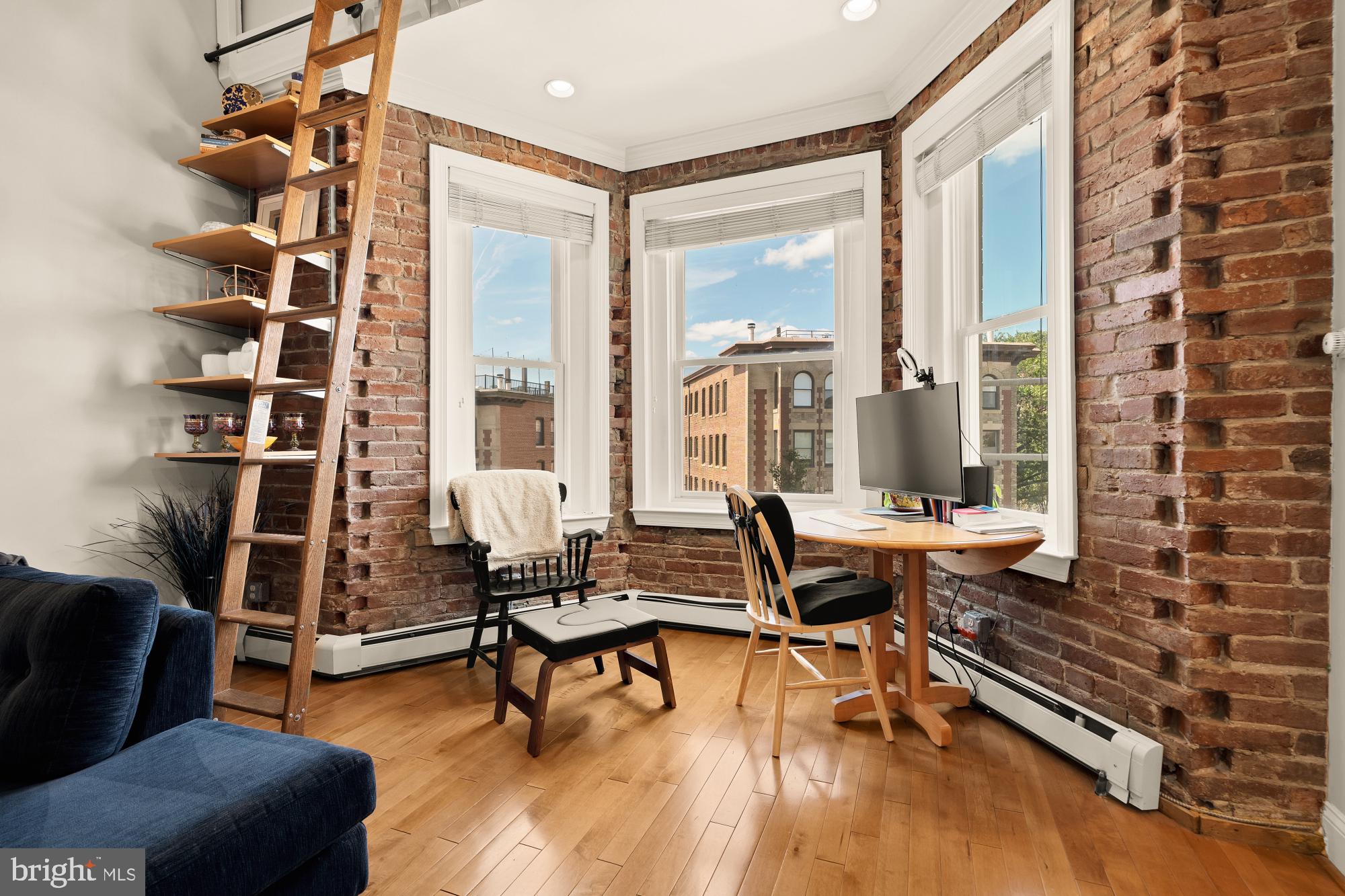 1933 18th Street Northwest, Unit 304 Washington, DC 20009 - Photo 7 of 24 a living room with furniture a rug and a floor to ceiling window
