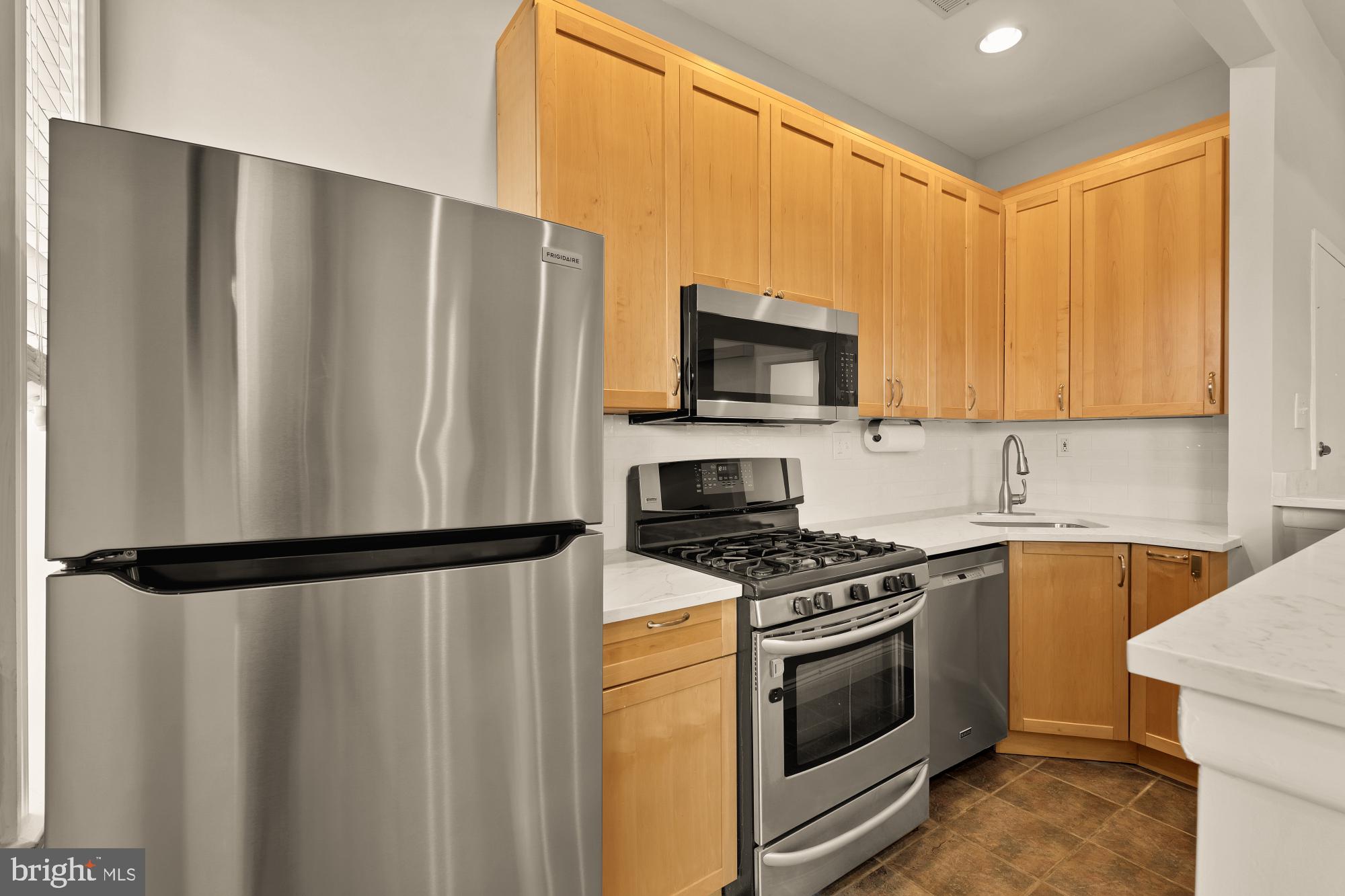 1933 18th Street Northwest, Unit 304 Washington, DC 20009 - Photo 10 of 24 a kitchen with a refrigerator stove and microwave