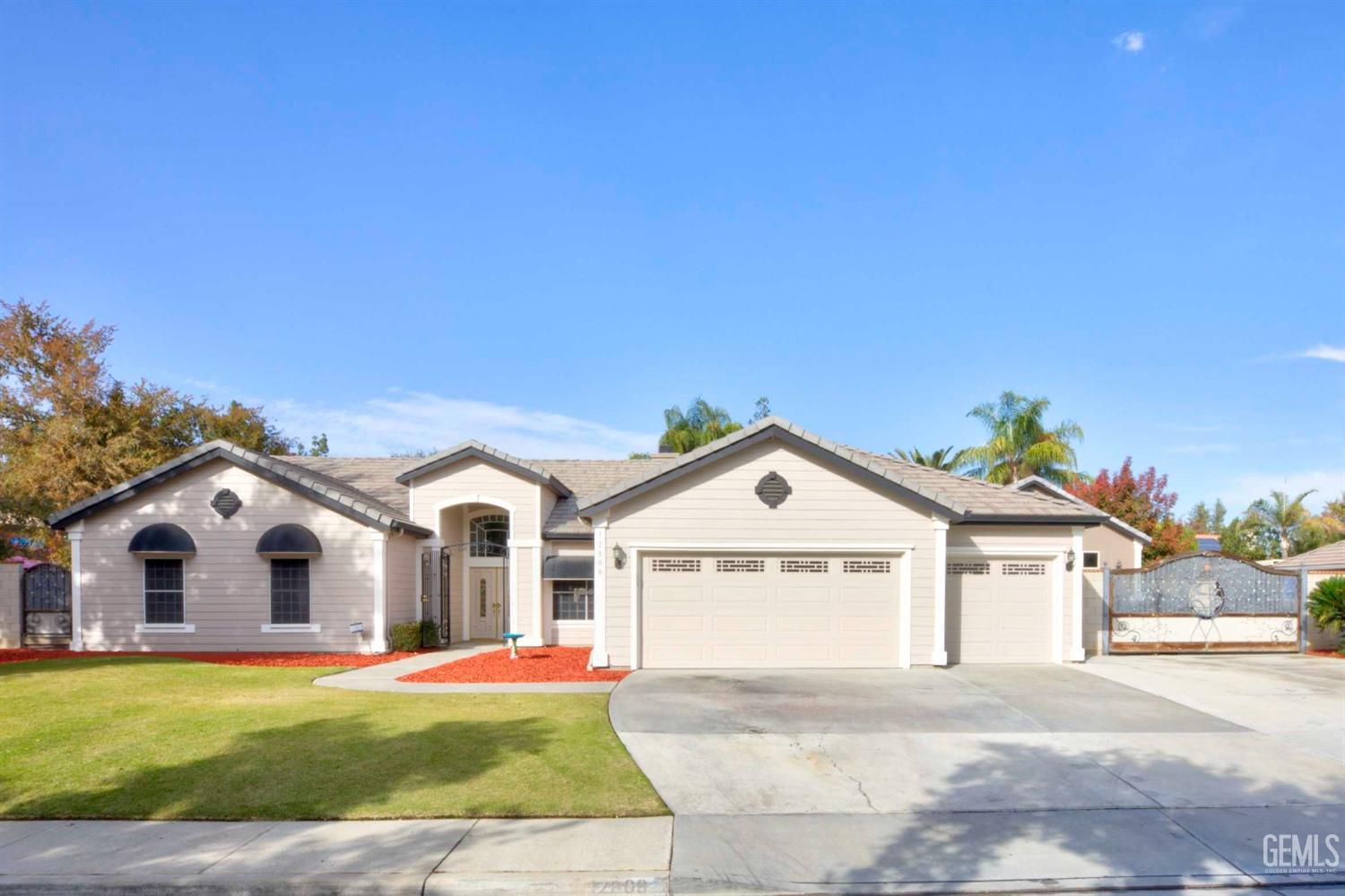 Undisclosed Address Bakersfield, CA 93312 - Photo 1 of 33 a view of white house with a yard and garage