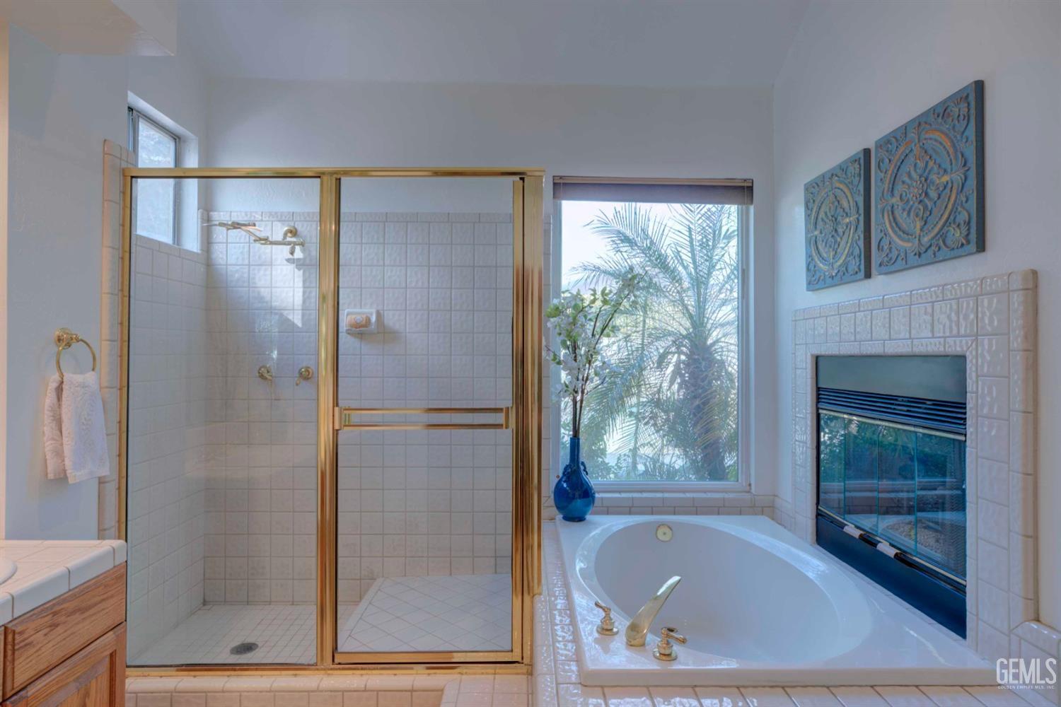 Undisclosed Address Bakersfield, CA 93312 - Photo 11 of 33 a bathroom with a bathtub and a shower