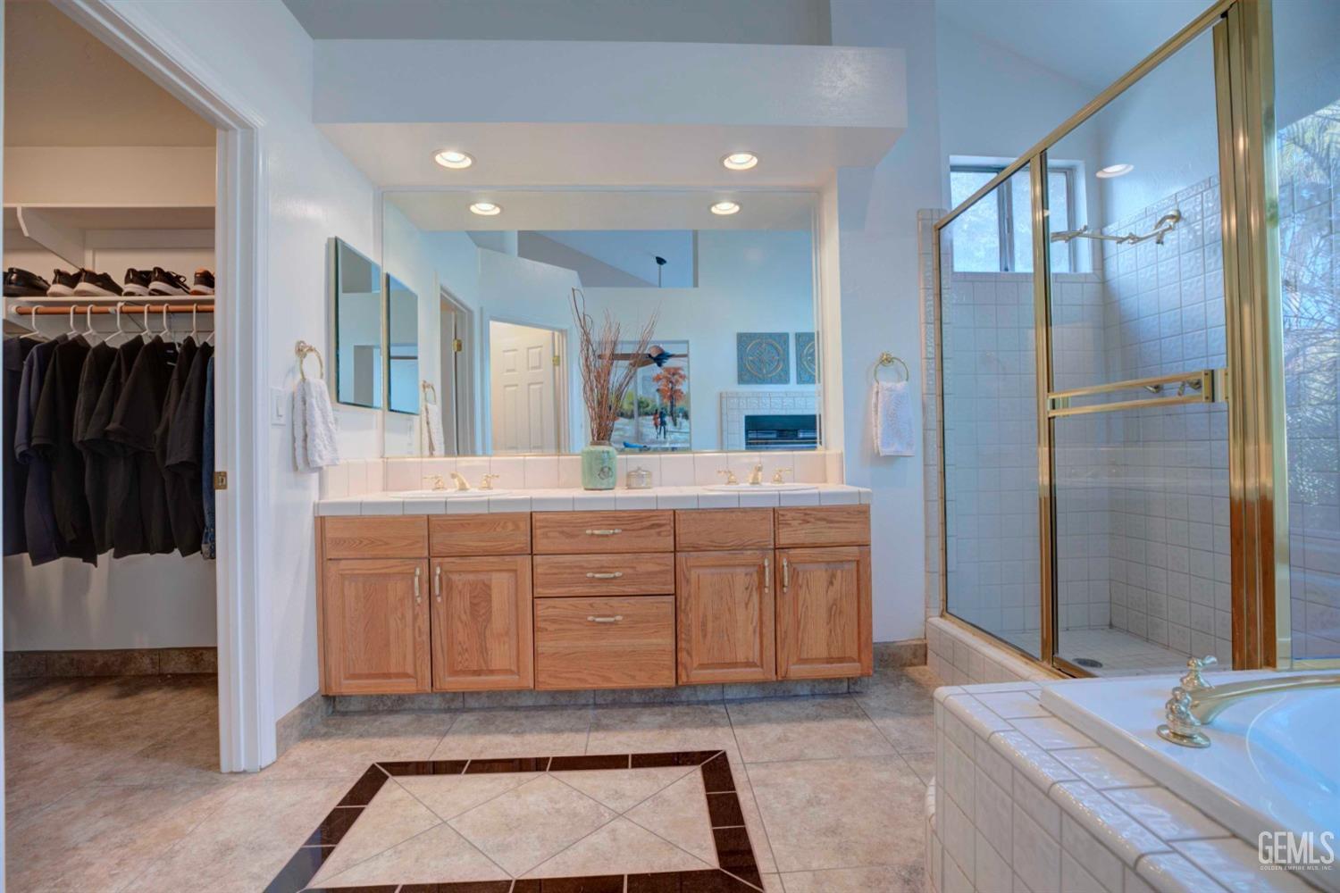 Undisclosed Address Bakersfield, CA 93312 - Photo 12 of 33 a large bathroom with a glass door shower and a sink