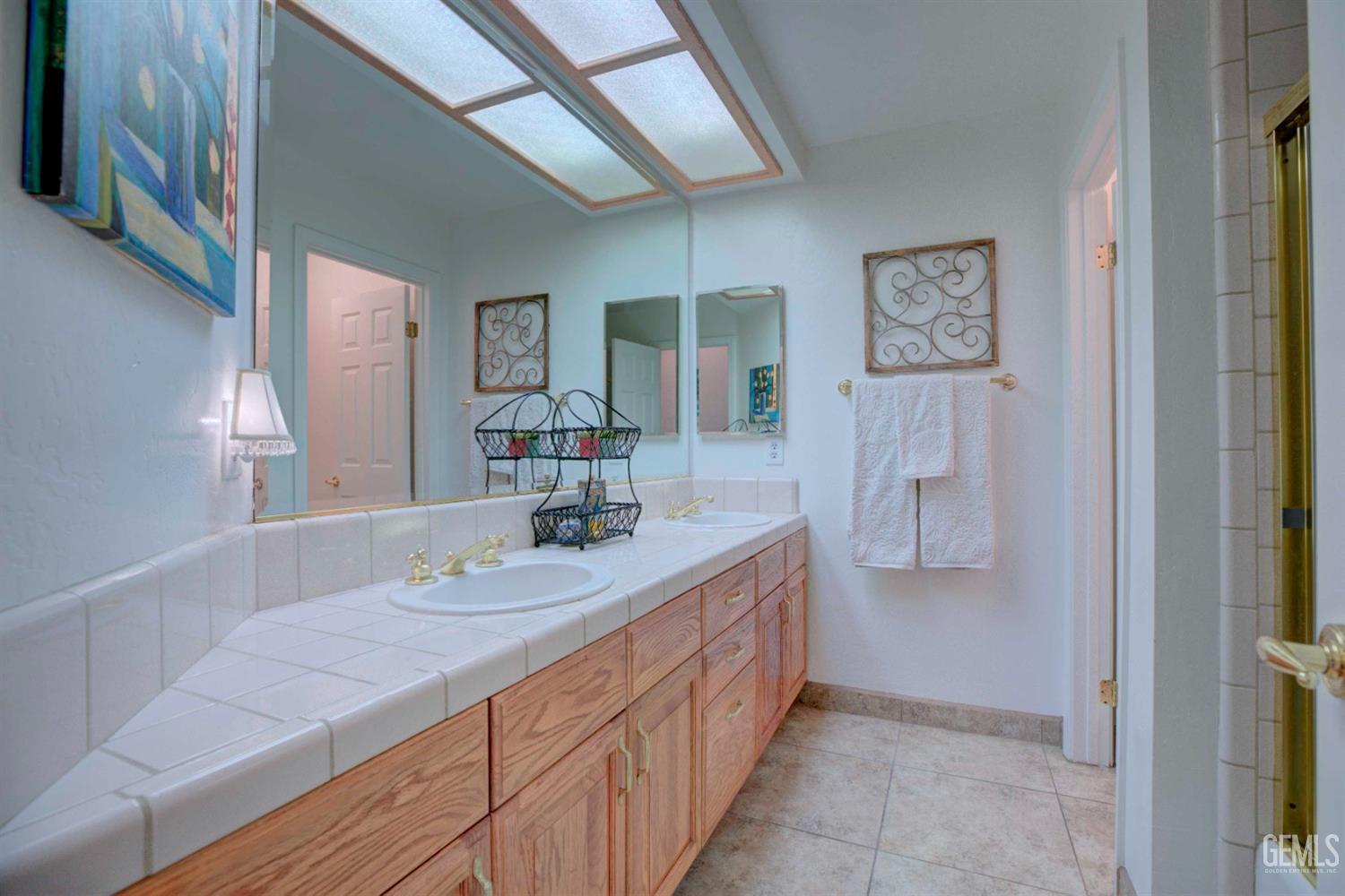 Undisclosed Address Bakersfield, CA 93312 - Photo 15 of 33 a bathroom with a sink and a mirror