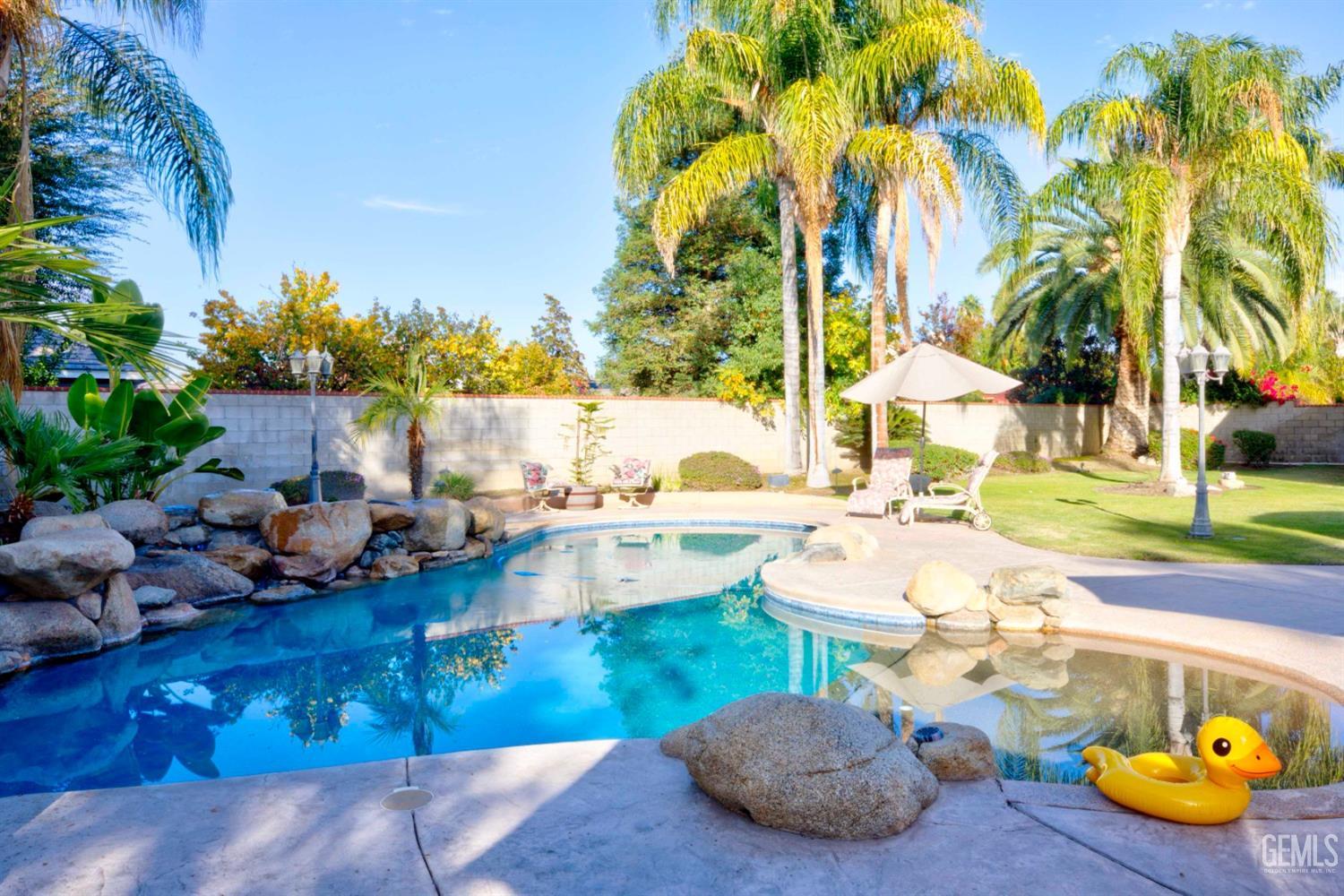 Undisclosed Address Bakersfield, CA 93312 - Photo 20 of 33 a view of a swimming pool and lounge chairs