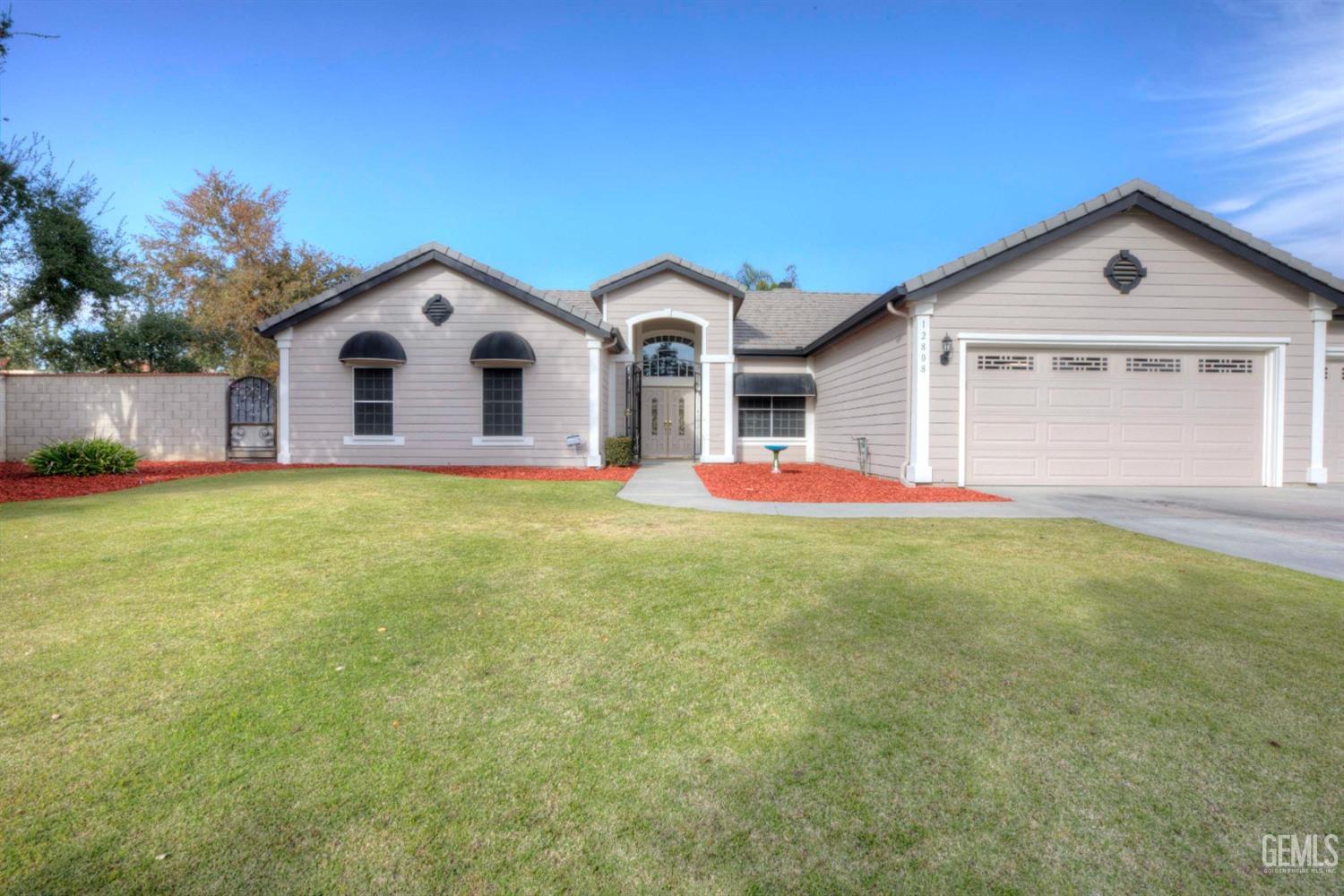 Undisclosed Address Bakersfield, CA 93312 - Photo 2 of 33 a view of a house with a yard and garage