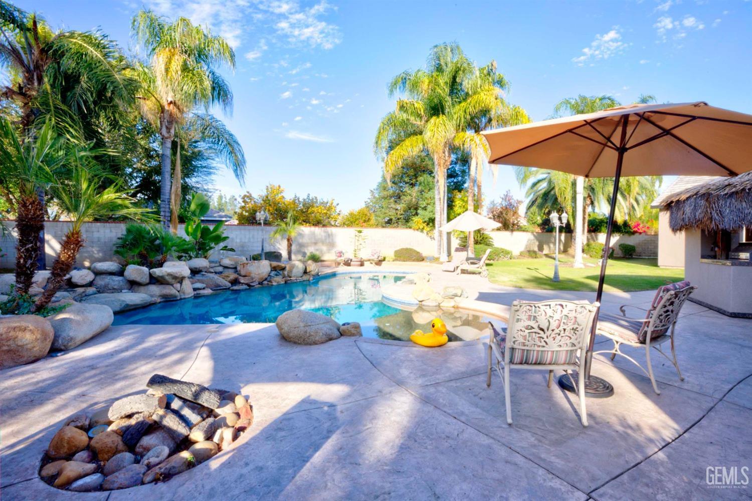 Undisclosed Address Bakersfield, CA 93312 - Photo 23 of 33 a view of a swimming pool with a patio