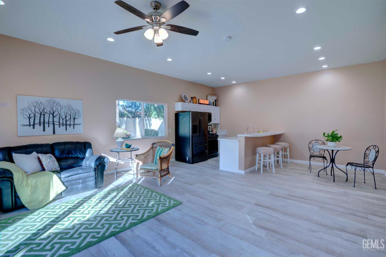 Undisclosed Address Bakersfield, CA 93312 - Photo 24 of 33 a living room with furniture and wooden floor