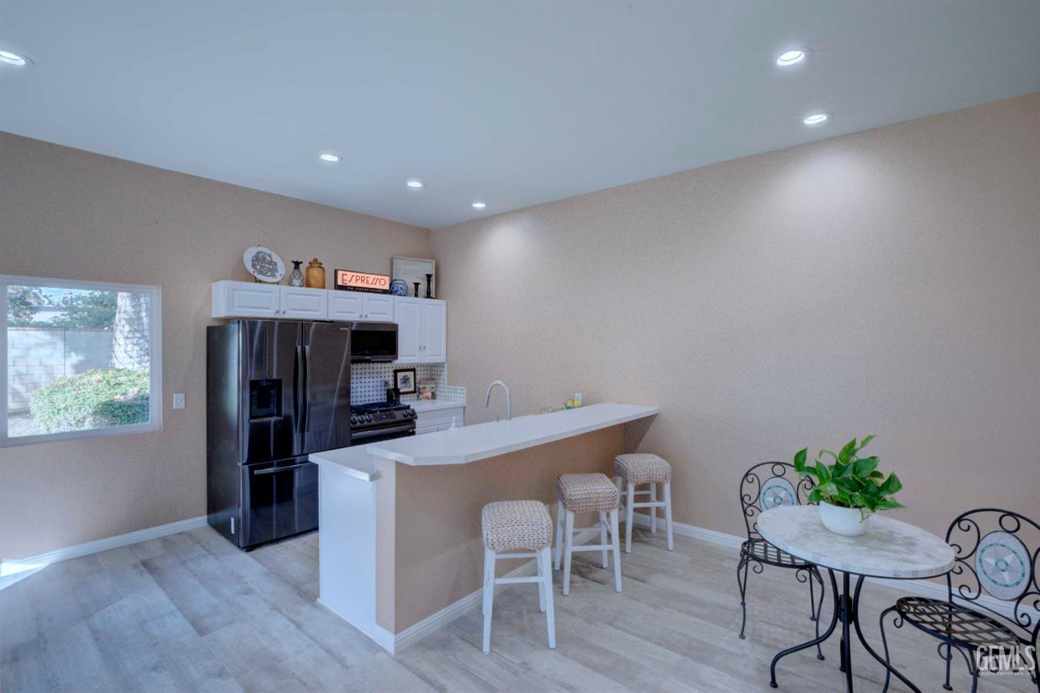 Undisclosed Address Bakersfield, CA 93312 - Photo 25 of 33 a view of a dining room with furniture and wooden floor