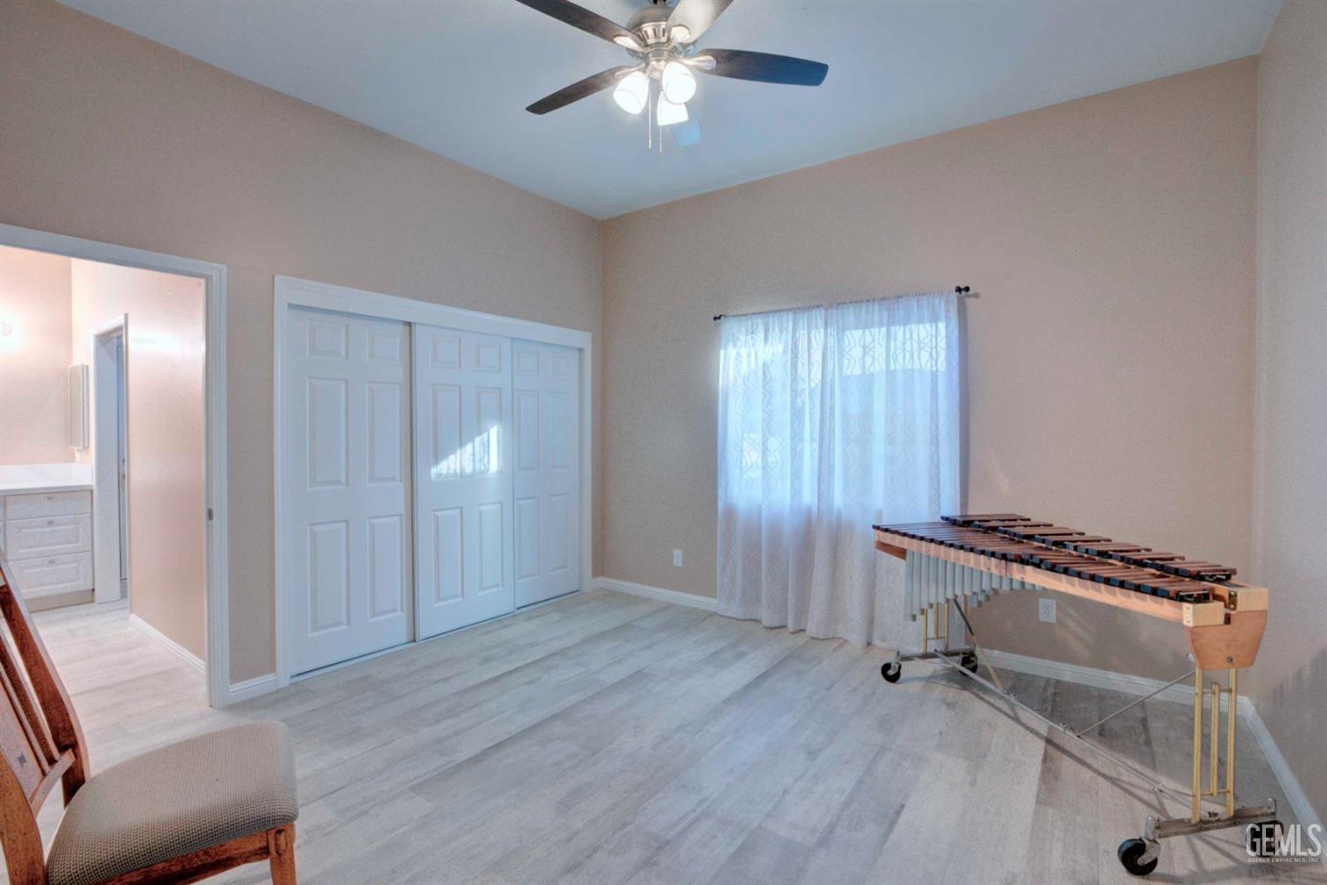 Undisclosed Address Bakersfield, CA 93312 - Photo 30 of 33 a view of an empty room with a window and wooden floor