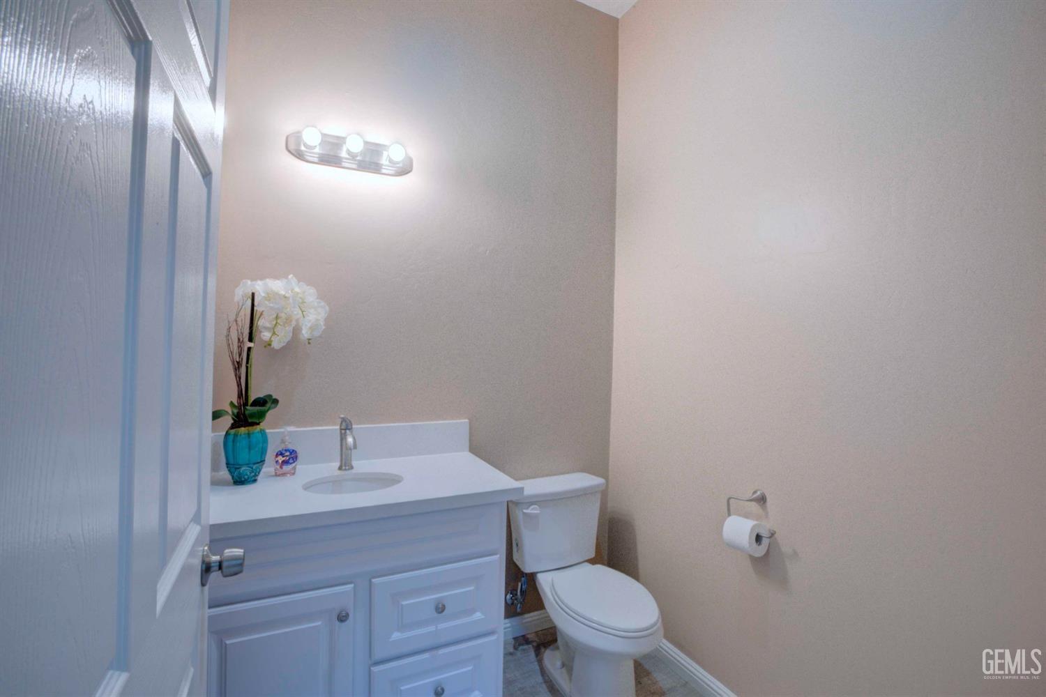 Undisclosed Address Bakersfield, CA 93312 - Photo 31 of 33 a bathroom with a toilet a sink and mirror