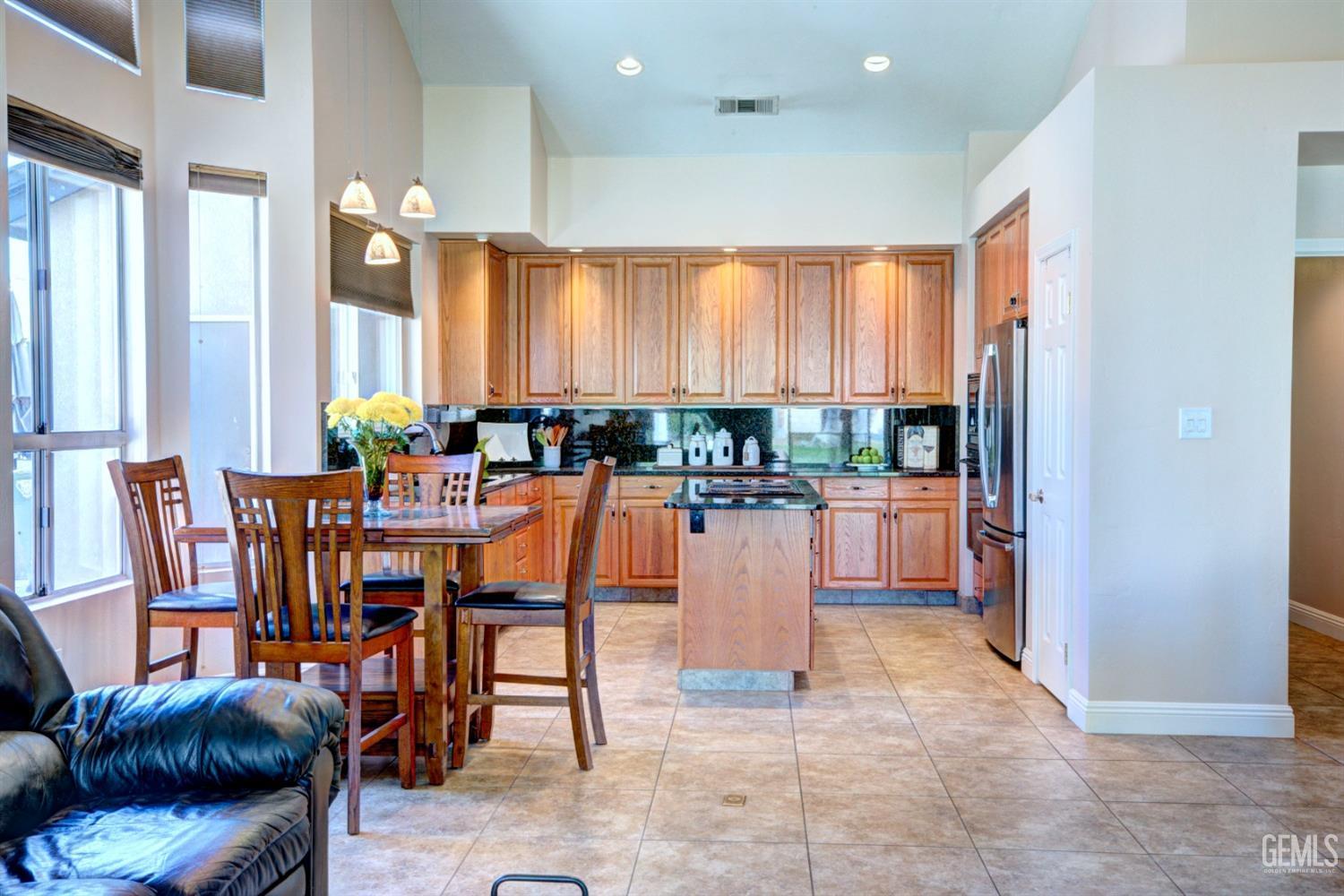 Undisclosed Address Bakersfield, CA 93312 - Photo 7 of 33 a dining hall with stainless steel appliances a dining table and chairs