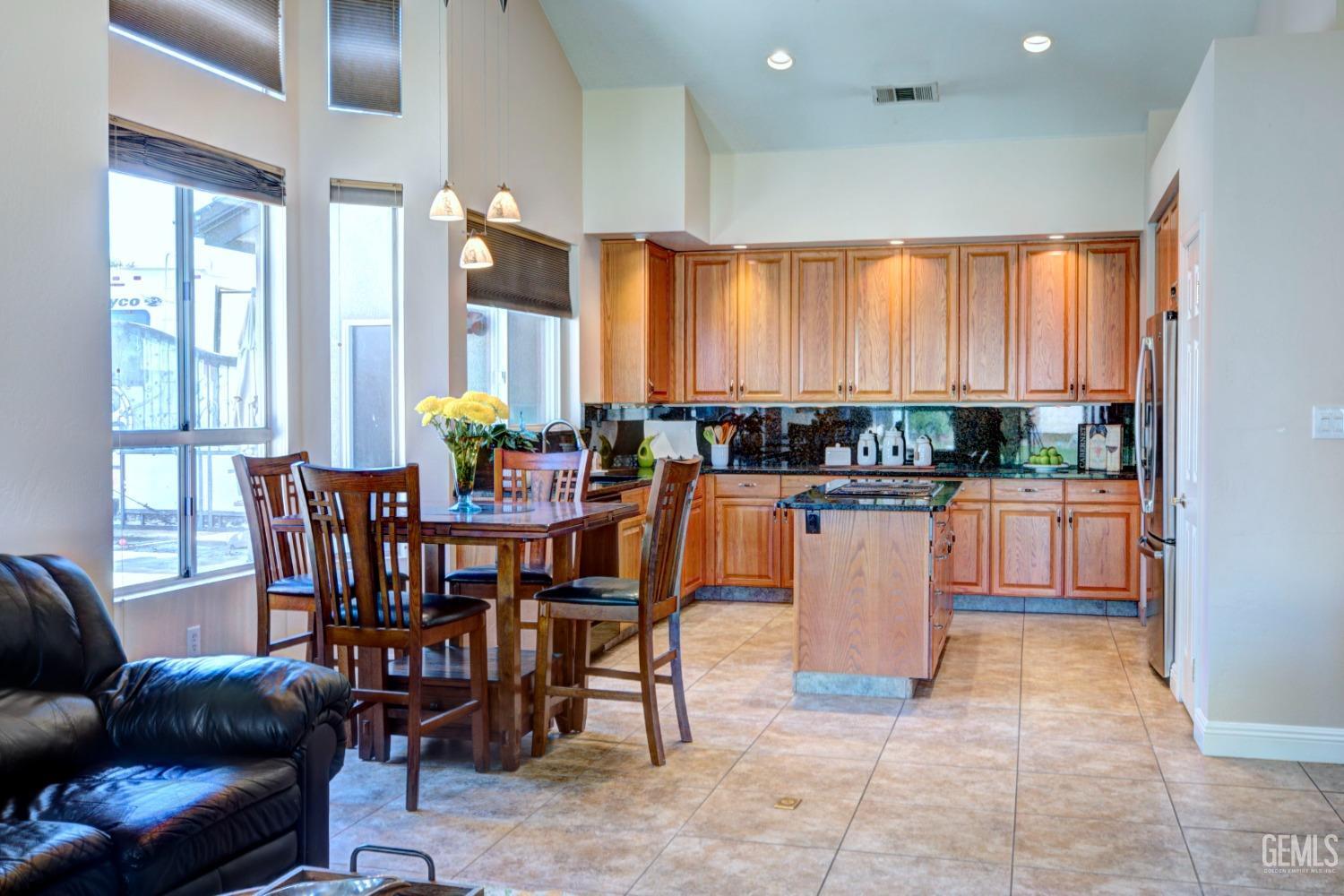 Undisclosed Address Bakersfield, CA 93312 - Photo 8 of 33 a dining hall with stainless steel appliances a dining table and chairs