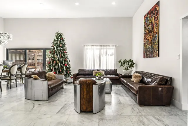 a living room with furniture potted plant and a chandelier