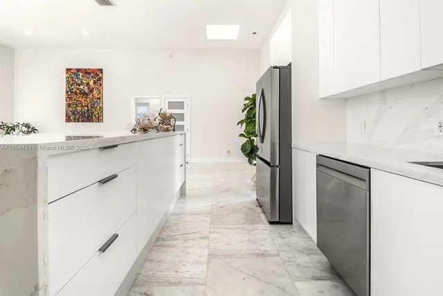 a kitchen with stainless steel appliances a refrigerator and a sink