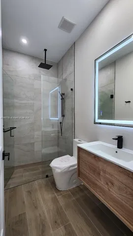 a bathroom with a tub a sink and mirror