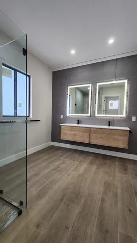 a view of empty room with kitchen and window