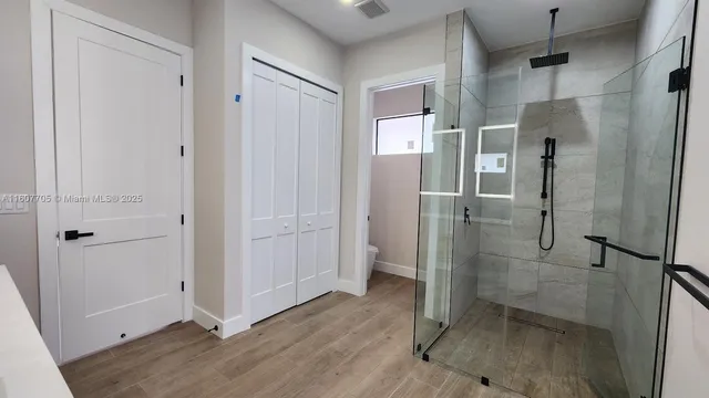 a bathroom with a glass shower door