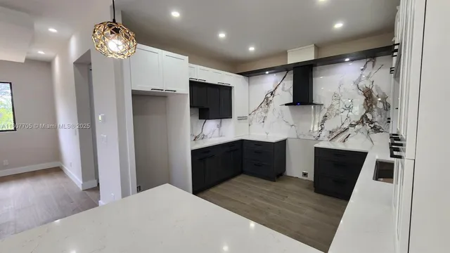 a kitchen with stainless steel appliances a refrigerator sink and microwave