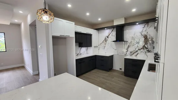 a kitchen with stainless steel appliances a refrigerator sink and microwave