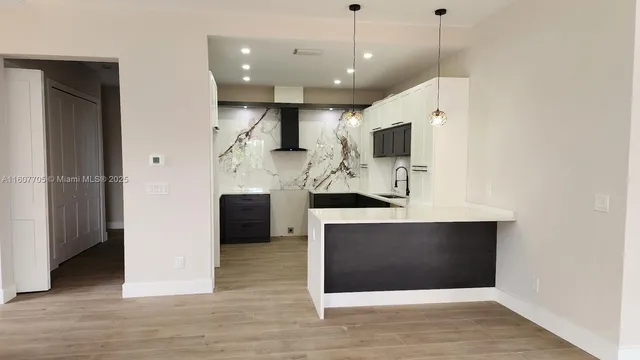 a view of living room with furniture and wooden floor
