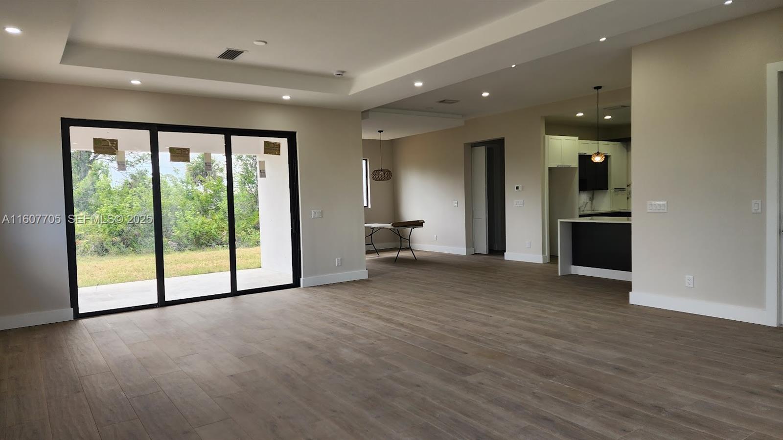 47 East Brig Circle Placida, FL 33946 - Photo 8 of 39 a view of empty room with wooden floor and fan