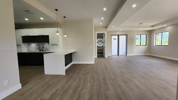 a view of kitchen with cabinets and wooden floor