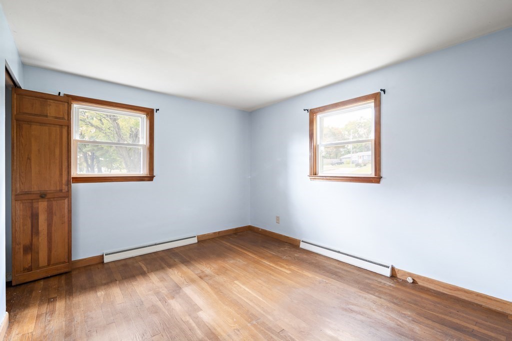 53 Cochato Park Randolph, MA 02368 - Photo 11 of 20 a view of an empty room with wooden floor and a window