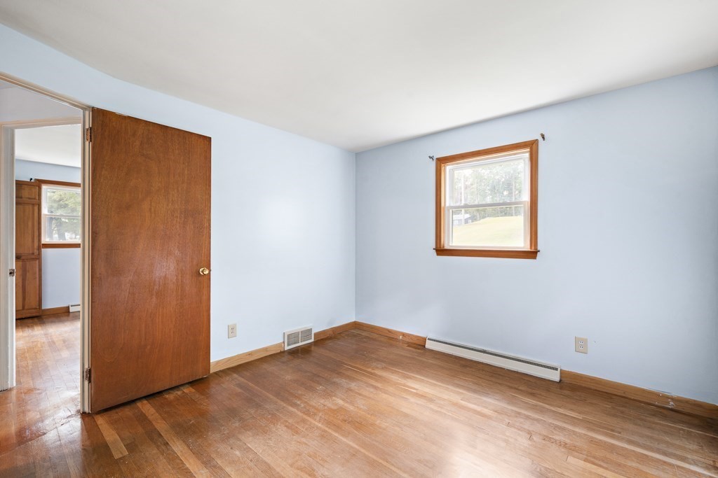 53 Cochato Park Randolph, MA 02368 - Photo 12 of 20 an empty room with wooden floor and windows