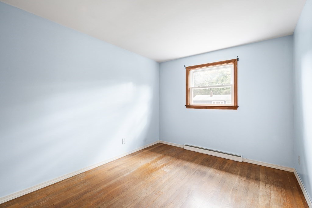 53 Cochato Park Randolph, MA 02368 - Photo 13 of 20 a view of an empty room with wooden floor and a window
